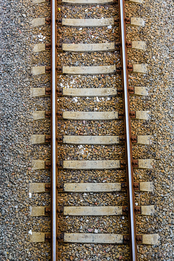 Top view of railroad tracks on gravel