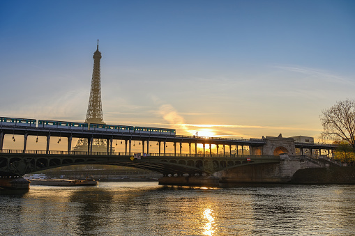 Paris France city skyline sunrise at Eiffel Tower and Seine River with Pont de Bir-Hakeim bridge and Paris Metro