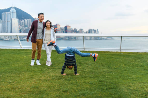 istock Chinese Boy Attempting Cartwheel at Ocean Terminal Deck 1173739164