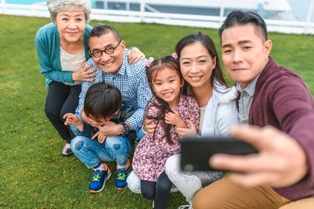 high angle view of chinese family taking outdoor selfie - harbour city imagens e fotografias de stock