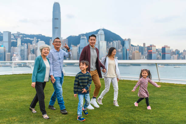 happy chinese family enjoying views from ocean terminal deck - harbour city imagens e fotografias de stock