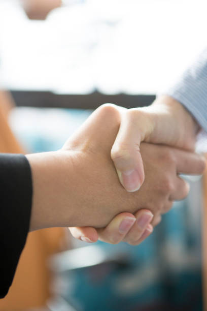 istock Two women shaking hands at meeting 1173739264
