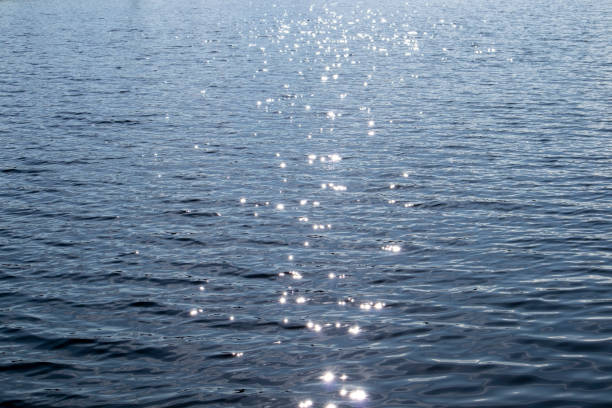 sun sparkling on water surface sun sparkling on water surface glittering sea stock pictures, royalty-free photos & images