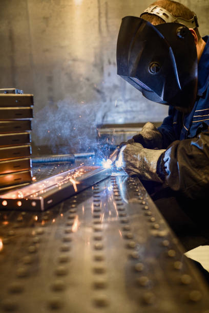 istock Working welder welds parts factory 1173740403