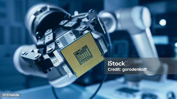 Modern High Tech Authentic Robot Arm Holding Contemporary Super Computer Processor Industrial Robotic Manipulator End Effector Holding Cpu Chip Stock Photo - Download Image Now