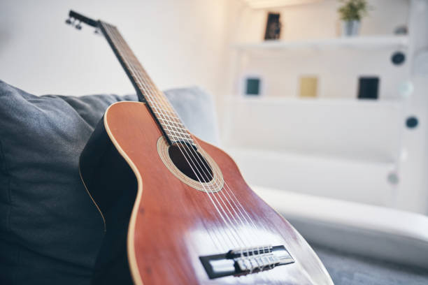 istock Acoustic guitar on a living room couch / sofa. 1173741177