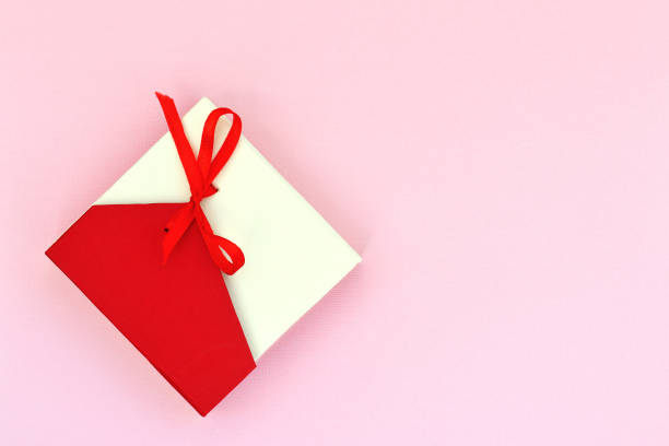 istock Red with beige gift box on a pink background. Flat lay top view copy space 1173742826