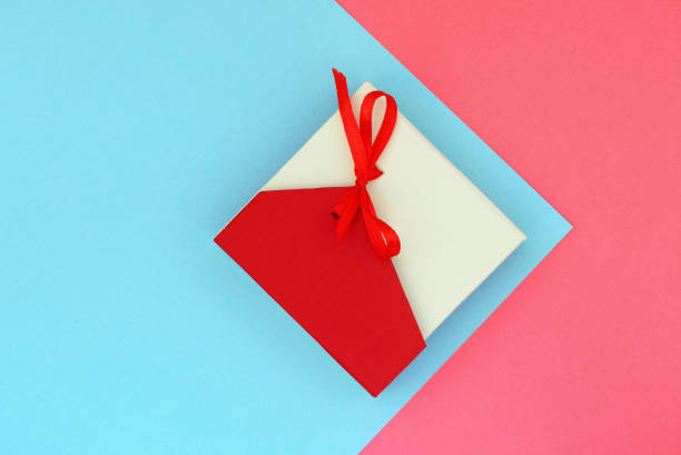 istock Red with beige gift box on a pink and blue background. Flat lay top view copy space 1173742838