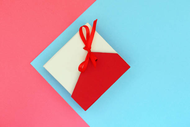 istock Red with beige gift box on a pink and blue background. Flat lay top view copy space 1173742843