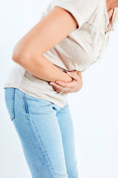 istock Woman with stomach/ hip issues / problems on the white background. 1173743026