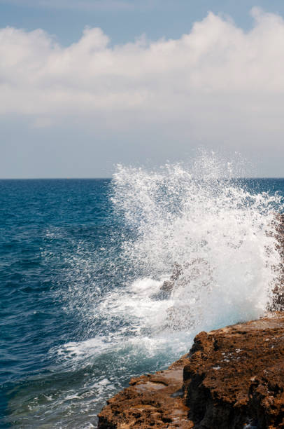 istock waves crashing on the rocks in Italy 1173744047