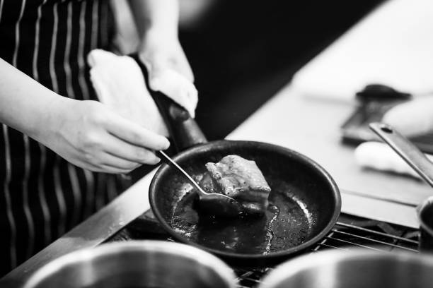 istock chef preparing food, chef cooking in a kitchen, chef at work, Black & White 1173747030