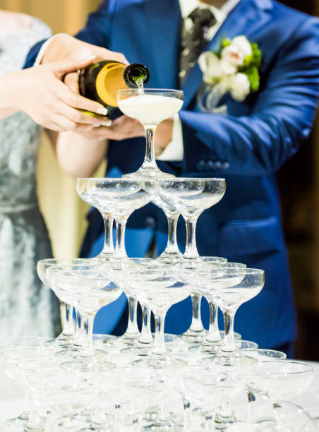 istock Couple pouring champagne in glasses 1173747249