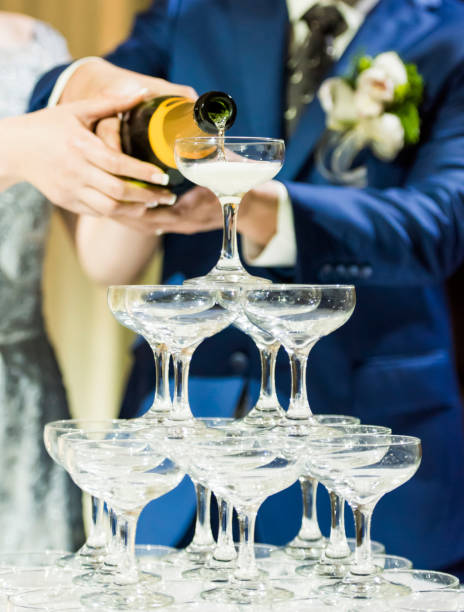 istock Couple pouring champagne in glasses 1173747349