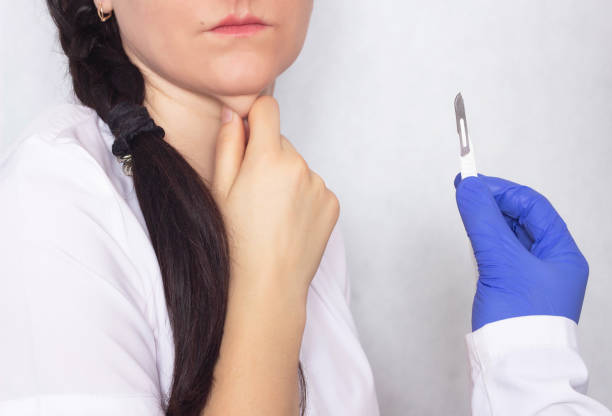 Plastic surgeon holding a scalpel in her hand against the background of a girl with a double chin, the obsolescence of a double chin in plastic surgery Plastic surgeon holding a scalpel in her hand against the background of a girl with a double chin, the obsolescence of a double chin in plastic surgery, closeup fat ugly face stock pictures, royalty-free photos & images