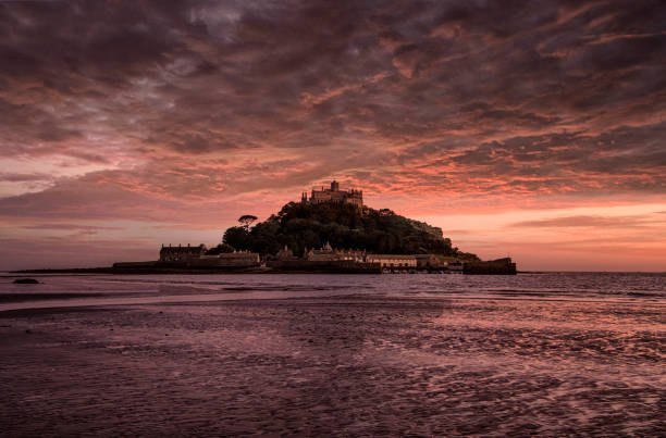 istock Dramatic sunset on the beach at Marazion with St Michaels Mount, Cornwall 1173750121