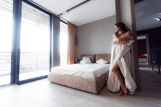 istock Woman enjoying the morning sunlight from window 1173750215