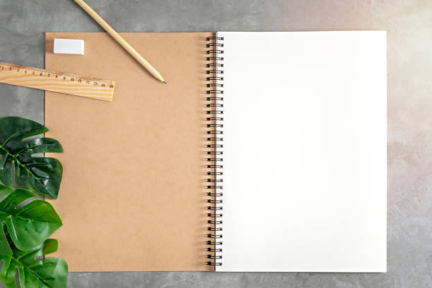 istock blank sketchbook and green leaves 1173750670