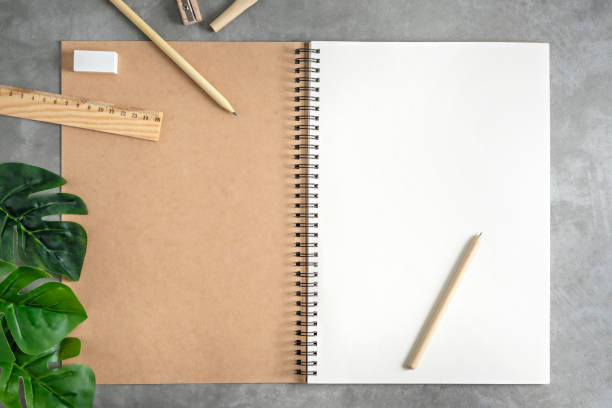 istock blank sketchbook and green leaves 1173750676