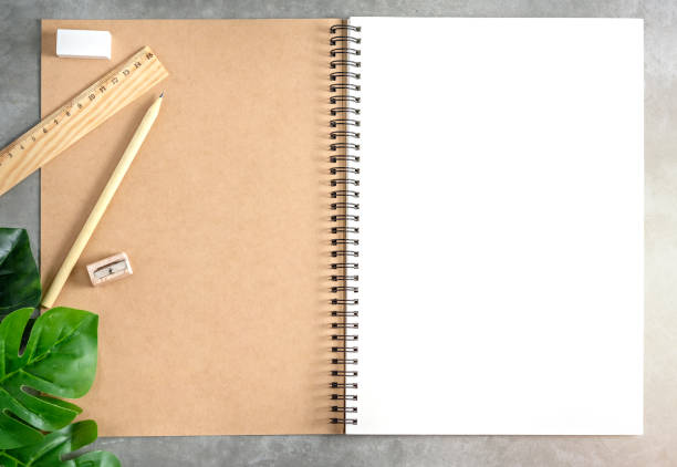 istock blank sketchbook and green leaves 1173751787