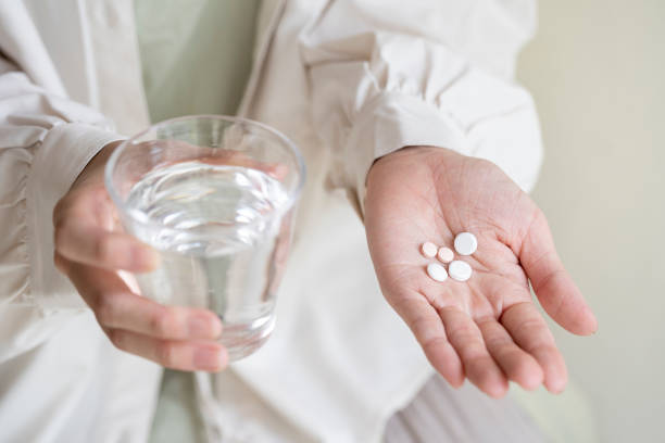 istock Hand of woman with pills 1173752456
