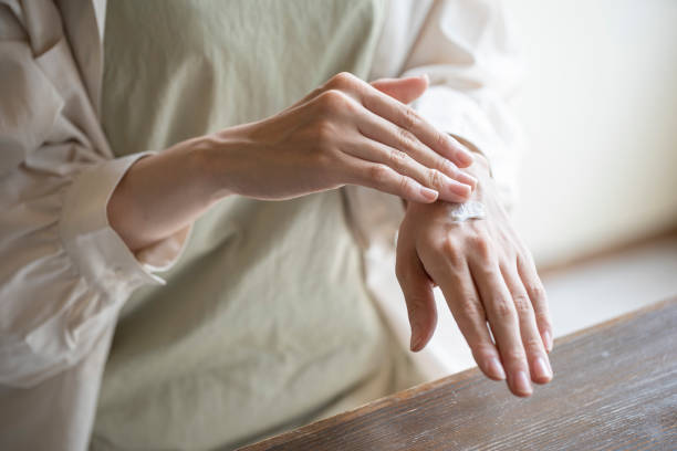 istock Hands of woman applying hand cream 1173753090