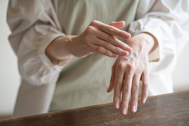 istock Hands of woman applying hand cream 1173753731