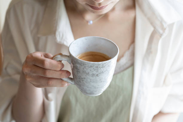 istock Hand of woman drinking coffee 1173753732
