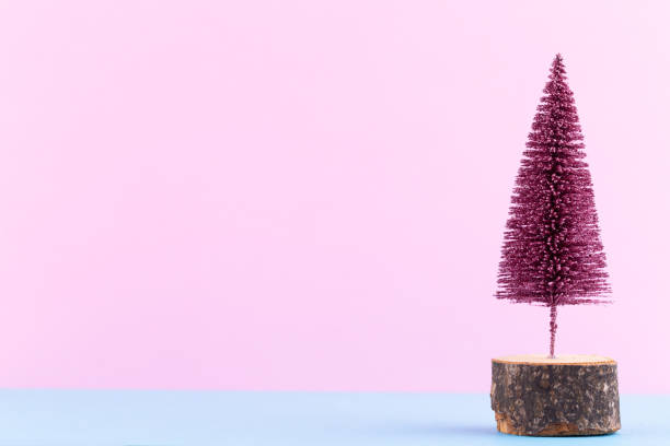 istock Christmas tree on pastel colored background. Christmas or New Year minimal concept. 1173756152