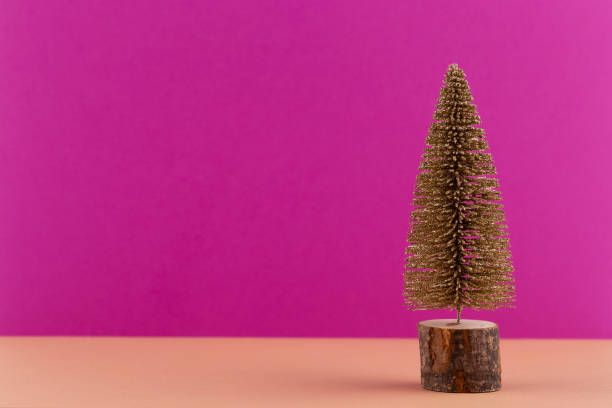 istock Christmas tree on pastel colored background. Christmas or New Year minimal concept. 1173756355