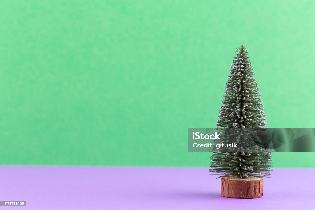 Christmas tree on pastel colored background. Christmas or New Year minimal concept. Celebration Stock Photo