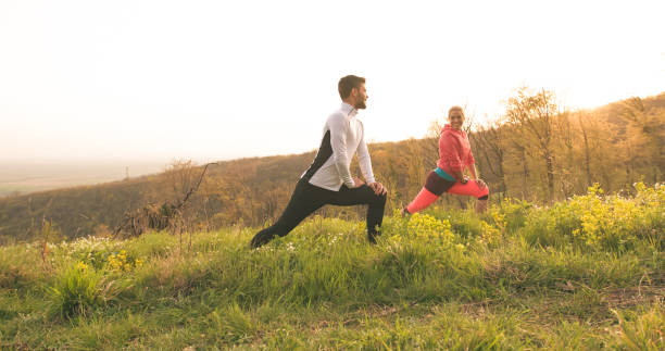 istock Young couple stretching after a workout in nature 1173756485