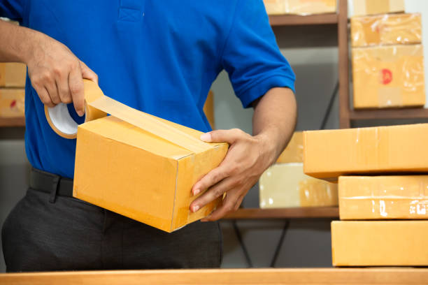 istock Worker courier man packing parcel box at office for delivery 1173756686