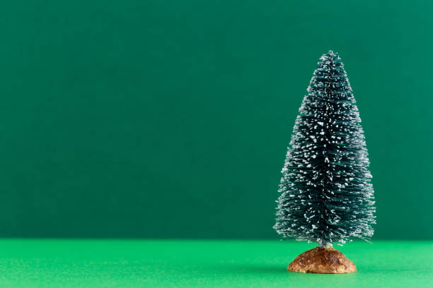 istock Christmas tree on pastel colored background. Christmas or New Year minimal concept. 1173758018