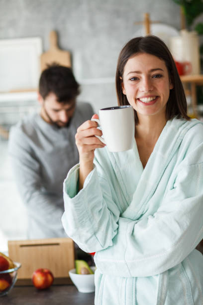 istock Smiling woman having morning coffee in the kitchen 1173762625