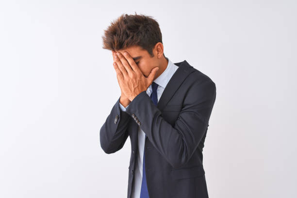 istock Young handsome businessman wearing suit standing over isolated white background with sad expression covering face with hands while crying. Depression concept. 1173767121