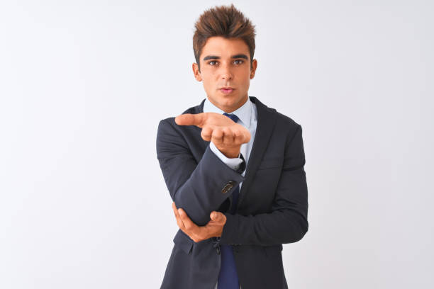 istock Young handsome businessman wearing suit standing over isolated white background looking at the camera blowing a kiss with hand on air being lovely and sexy. Love expression. 1173767131