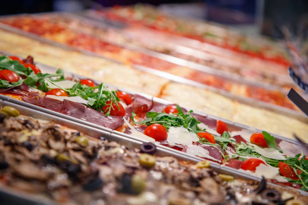 istock Focus on pizza with ham, cherry tomato, cheese and arugula 1173768545