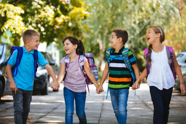 istock School children holding hands and going to school together 1173770308