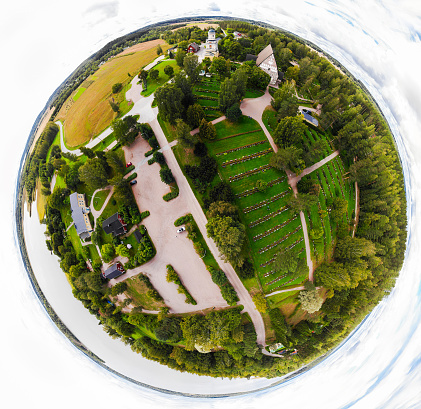 A three dimensional panoramic view of the medieval greystone Church of St. Mary in Hollola, Finland in a mini planet panorama style.