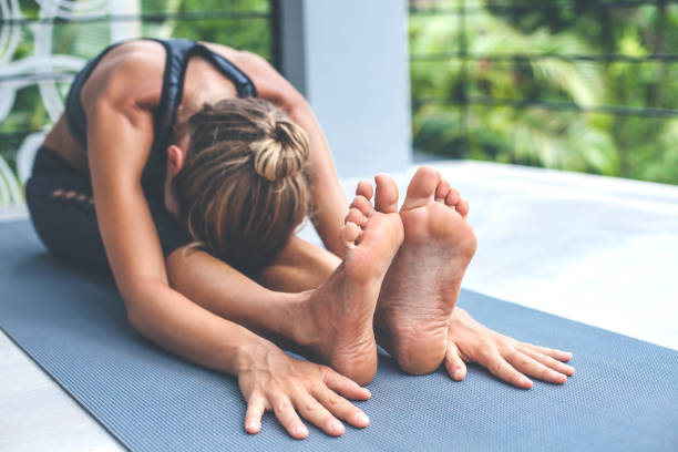 istock Young woman in Janu Sirsasana pose 1173771086