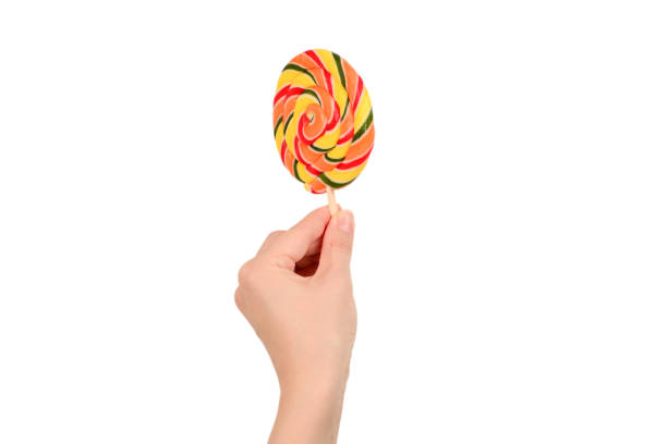 istock Lollipop in female hand isolated on white  background. Space for text or design. 1173771756
