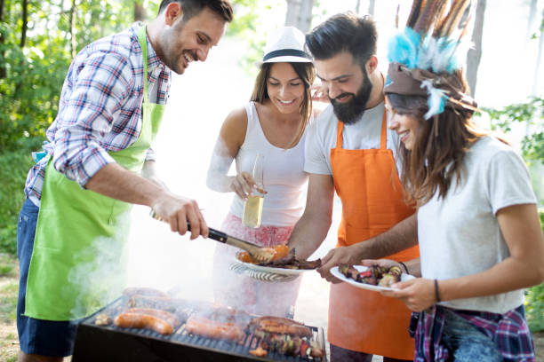 istock Friends having a barbecue party in nature while having fun 1173772069