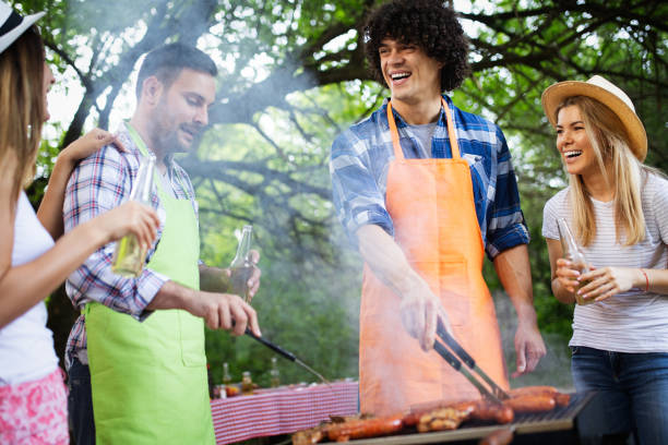 istock Happy friends camping and having a barbecue in nature 1173772282