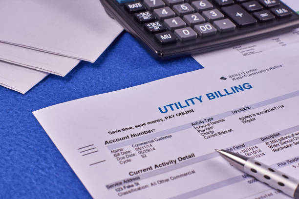 Utility bill Communal payments. Utility billing sheet, calculator, pen and envelopes on a blue velvet background energy bill photos stock pictures, royalty-free photos & images