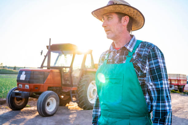 istock Agriculture farmer and tractor 1173775103