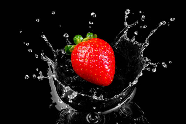 strawberry falling into the water - wet strawberry macro fruit imagens e fotografias de stock