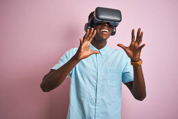 istock Young african american man playing virtual reality game using goggles 1173778489