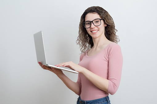 Beautiful young woman holding laptop