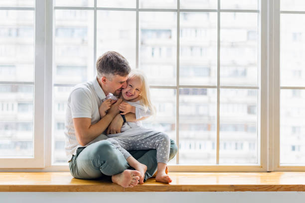 istock Happy father hugs her cute girl while having fun together 1173781992